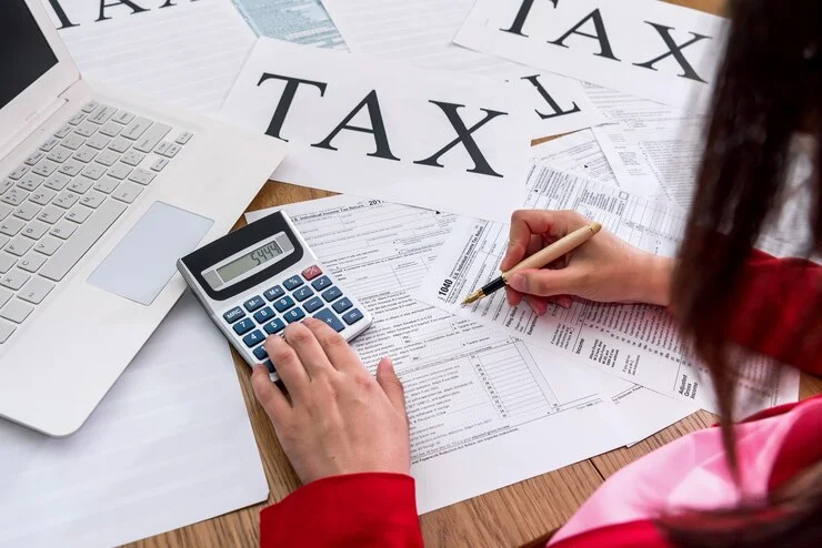 Tax documents and calculator on a desk